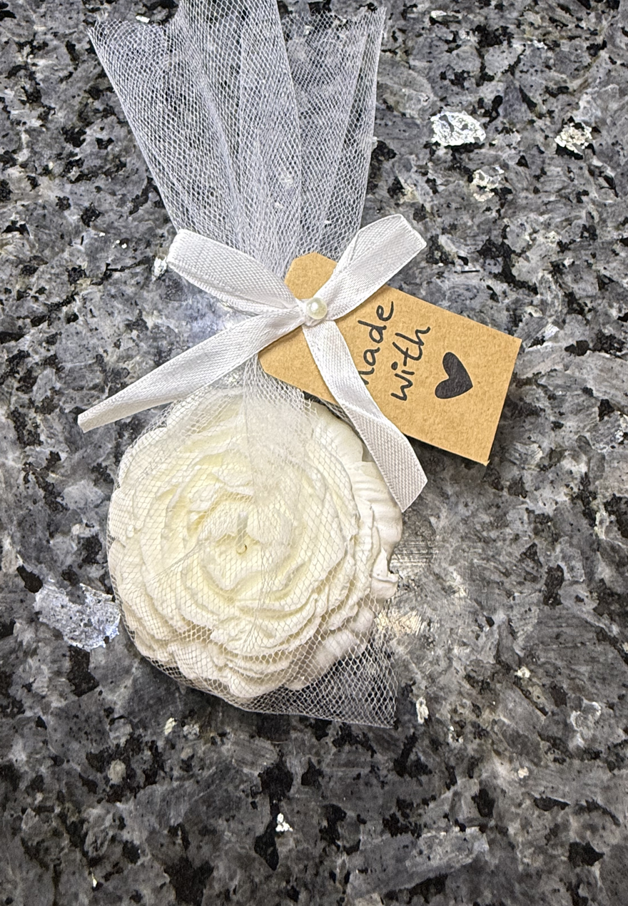 Ivory rose favor candle styled in a home-inspired scene